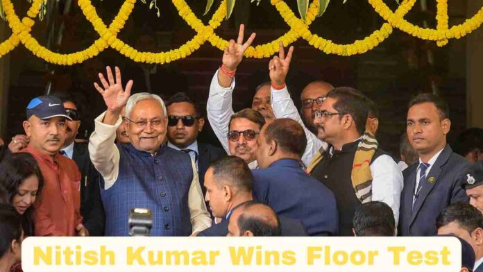 Image of Nitish Kumar celebrating with raised hands after winning the Bihar floor test.