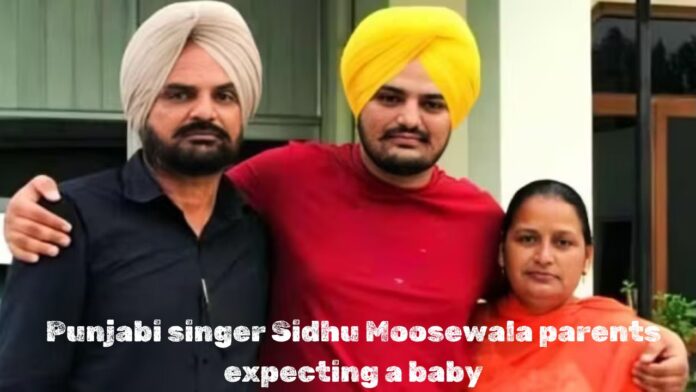 Image of late Punjabi singer Sidhu Moosewala standing with his parents, with the text "Punjabi singer Sidhu Moosewala parents expecting a baby" written below.